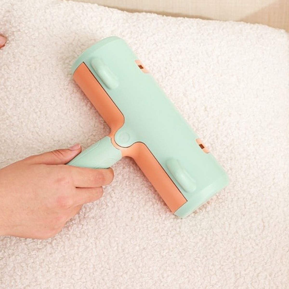Close-up of brush being used on a cushion
